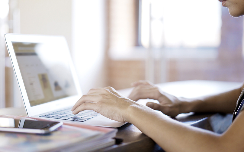 person typing on laptop